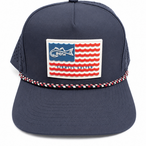 Navy blue cap with American flag patch and braided trim on a white background