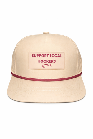Beige cap with red band and text 'Support Local Hookers' on a white background